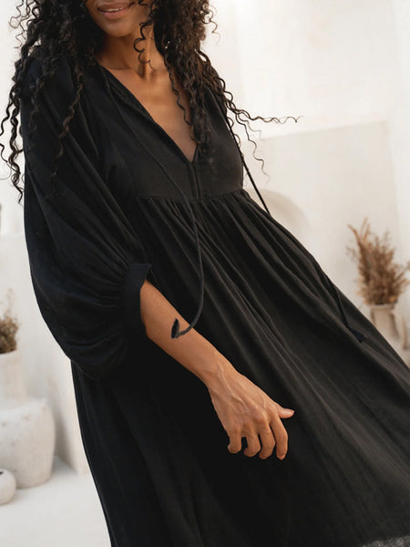 Casual Loose-Fitting Maxi Dress for Women with Lantern Sleeves, a V-Neck, And a Flowy Swing Design. Features 3/4 Puff Sleeves, Perfect for Boho Beach Outings, with a Tie-Up Front And Ruffled Details, Ideal for Vacations