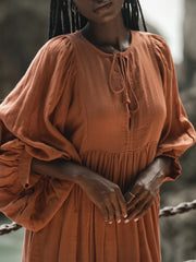 Casual Loose-Fitting Maxi Dress for Women with Lantern Sleeves, a V-Neck, And a Flowy Swing Design. Features 3/4 Puff Sleeves, Perfect for Boho Beach Outings, with a Tie-Up Front And Ruffled Details, Ideal for Vacations