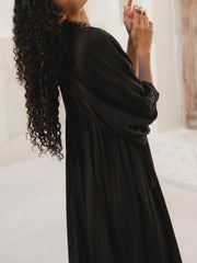 Casual Loose-Fitting Maxi Dress for Women with Lantern Sleeves, a V-Neck, And a Flowy Swing Design. Features 3/4 Puff Sleeves, Perfect for Boho Beach Outings, with a Tie-Up Front And Ruffled Details, Ideal for Vacations