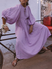 Casual Loose-Fitting Maxi Dress for Women with Lantern Sleeves, a V-Neck, And a Flowy Swing Design. Features 3/4 Puff Sleeves, Perfect for Boho Beach Outings, with a Tie-Up Front And Ruffled Details, Ideal for Vacations
