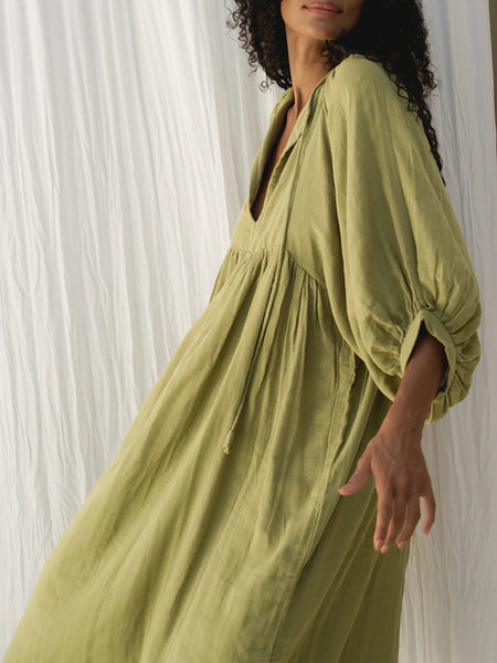 Casual Loose-Fitting Maxi Dress for Women with Lantern Sleeves, a V-Neck, And a Flowy Swing Design. Features 3/4 Puff Sleeves, Perfect for Boho Beach Outings, with a Tie-Up Front And Ruffled Details, Ideal for Vacations