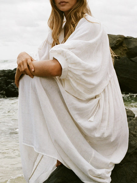 Casual Loose-Fitting Maxi Dress for Women with Lantern Sleeves, a V-Neck, And a Flowy Swing Design. Features 3/4 Puff Sleeves, Perfect for Boho Beach Outings, with a Tie-Up Front And Ruffled Details, Ideal for Vacations