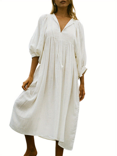 Casual Loose-Fitting Maxi Dress for Women with Lantern Sleeves, a V-Neck, And a Flowy Swing Design. Features 3/4 Puff Sleeves, Perfect for Boho Beach Outings, with a Tie-Up Front And Ruffled Details, Ideal for Vacations