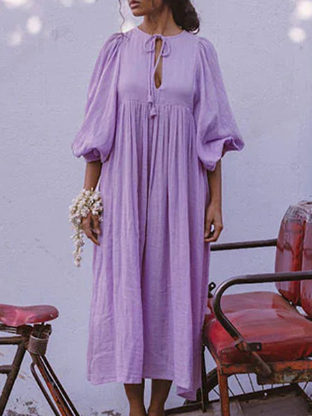 Casual Loose-Fitting Maxi Dress for Women with Lantern Sleeves, a V-Neck, And a Flowy Swing Design. Features 3/4 Puff Sleeves, Perfect for Boho Beach Outings, with a Tie-Up Front And Ruffled Details, Ideal for Vacations