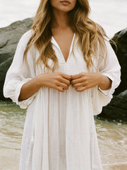 Casual Loose-Fitting Maxi Dress for Women with Lantern Sleeves, a V-Neck, And a Flowy Swing Design. Features 3/4 Puff Sleeves, Perfect for Boho Beach Outings, with a Tie-Up Front And Ruffled Details, Ideal for Vacations