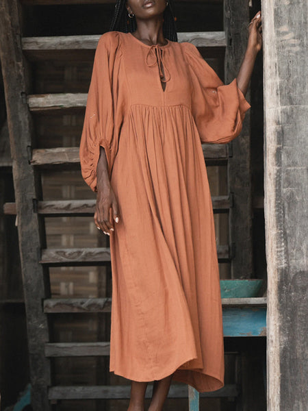 Casual Loose-Fitting Maxi Dress for Women with Lantern Sleeves, a V-Neck, And a Flowy Swing Design. Features 3/4 Puff Sleeves, Perfect for Boho Beach Outings, with a Tie-Up Front And Ruffled Details, Ideal for Vacations