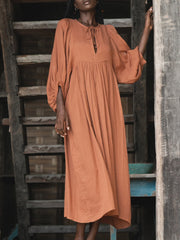 Casual Loose-Fitting Maxi Dress for Women with Lantern Sleeves, a V-Neck, And a Flowy Swing Design. Features 3/4 Puff Sleeves, Perfect for Boho Beach Outings, with a Tie-Up Front And Ruffled Details, Ideal for Vacations