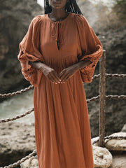 Casual Loose-Fitting Maxi Dress for Women with Lantern Sleeves, a V-Neck, And a Flowy Swing Design. Features 3/4 Puff Sleeves, Perfect for Boho Beach Outings, with a Tie-Up Front And Ruffled Details, Ideal for Vacations