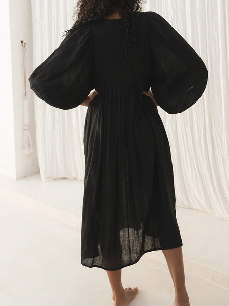 Casual Loose-Fitting Maxi Dress for Women with Lantern Sleeves, a V-Neck, And a Flowy Swing Design. Features 3/4 Puff Sleeves, Perfect for Boho Beach Outings, with a Tie-Up Front And Ruffled Details, Ideal for Vacations